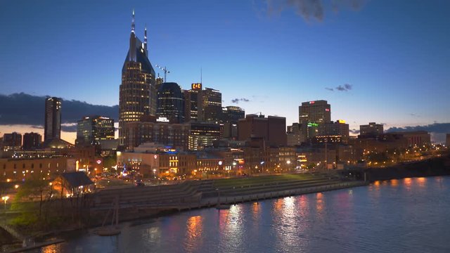 night view of downtown nashville, tennesse from a bridge over the cumberland river