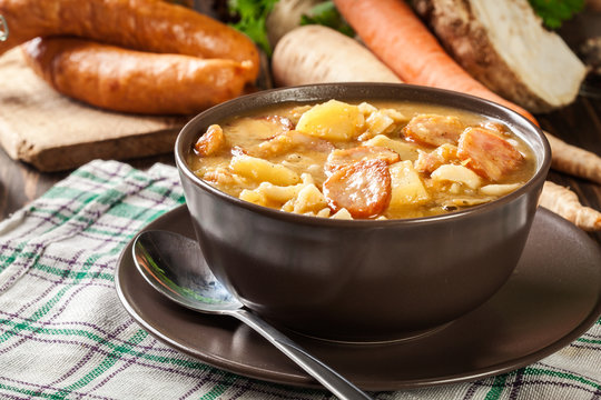 Traditional Polish split pea soup with sausage, bacon and potatoes