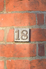 House number 18 sign on wall