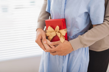 Fototapeta na wymiar Couple in love. Couple hugging with wrapped present