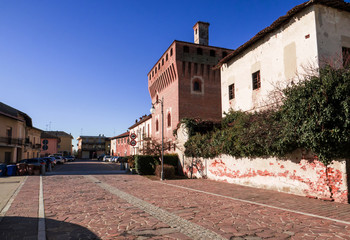 deserted village square with a medieval tower, Vicolungo, Italy