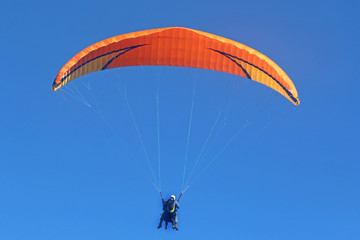 Tandem paraglider flying