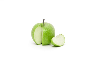 Fresh and Juicy Green Apple slice next to the fruit isolated