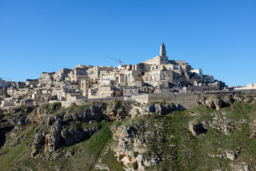 Fototapeta na wymiar View from the bottom of the canyon of the old town of Matera. Italy