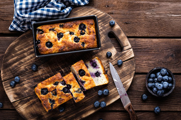 Cheesecake with blueberry on wooden background, top view
