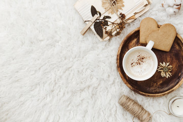 Cozy winter flat lay background, cup of coffee, old vintage paper on white background. Still life trendy composition for bloggers
