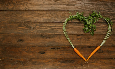 Carrot here shaped on a dark wood background. tinting. selective focus