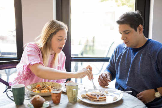 Young couple eating breakfast in a restaurant