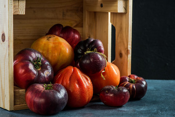 Ripe fresh tomatoes in wooden harvest box