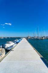 Fototapeta premium Long pier, jetty with yachts and boats