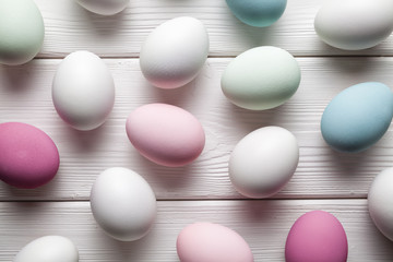 Happy Easter - colorful eggs on white wooden table
