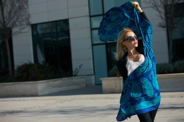 Blonde young woman with elegant blue scarf