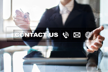 Contact us button and text on virtual screen. Business and technology concept.