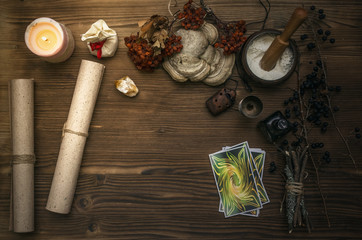 Tarot cards on fortune teller desk table. Witch doctor. Witchcraft. Magic herbal collection.