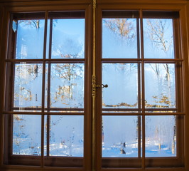 Ancient window in the snow-covered winter park