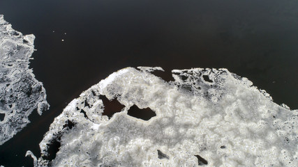 Ice comes to the river bank.