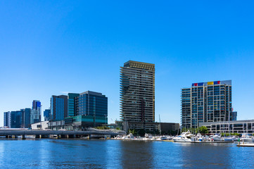 Fototapeta na wymiar Modern buildings on the bank of river on sunny day