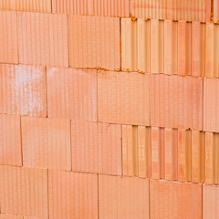new orange brick wall background. House building worker concept.