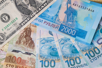 Fototapeta premium new Russian money banknotes and commemorative Olympic banknote with dollar on white background