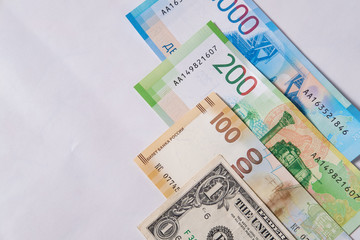 new Russian money banknotes and commemorative Olympic banknote with dollar on white background