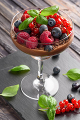 Ideas for a healthy diet: Dietary Chocolate mousse (parfait) with fresh berries of raspberries, blueberries and red currants in a glass goblet