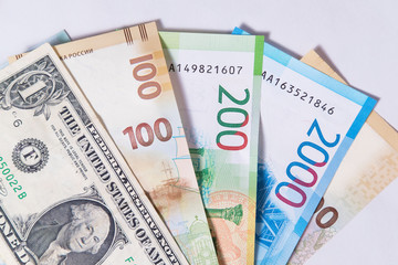 Obraz premium new Russian money banknotes and commemorative Olympic banknote with dollar on white background