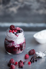 Chia pudding with yogurt and berries in glass jar