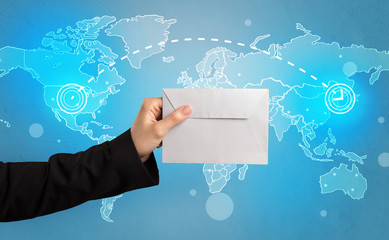 Hand holding envelope with global concept