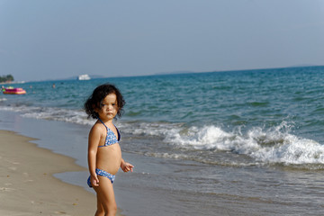 Fototapeta na wymiar little girl on the beach in summer Thailand