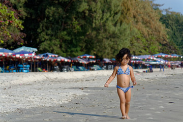 little girl on the beach in summer
