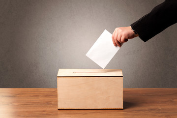 Ballot box with person casting vote