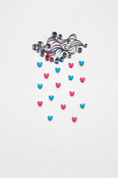 Raining love / Creative valentines concept photo of cloud with hearts raining down on white background.