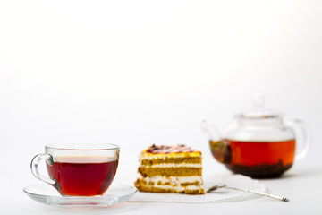 Teapot, tea cup and cake on white background