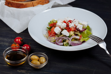 Close up of tasty greek salad with fresh vegetables