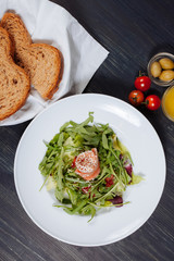 Top view of fresh salmon salad on the plate