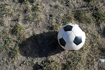 Abandoned soccer ball on the grass