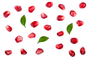 pomegranate seeds with leaves isolated on white background. Top view. Flat lay pattern