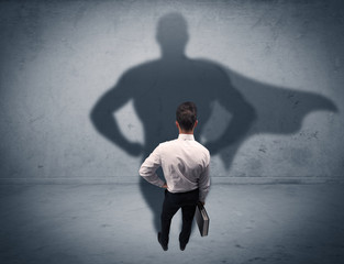 Successful businessman with superhero shadow
