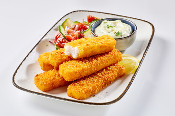 Close-up of fish fingers served with tartare sauce