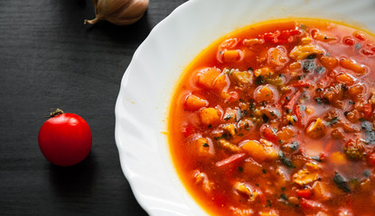 soup in plate on dark wooden background