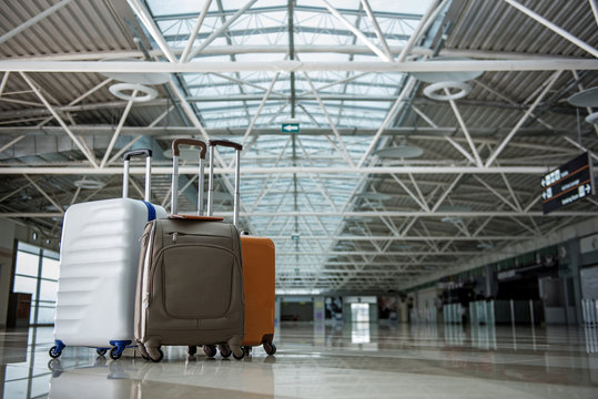 Three big suitcases standing close at the terminal hall. Copy space in right side