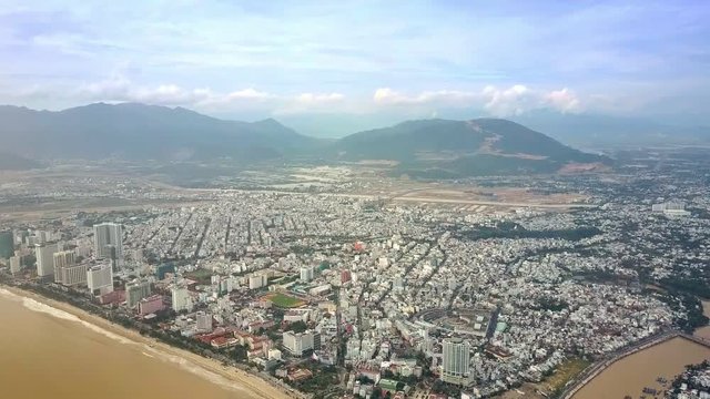Touristic City Washed by Brown Ocean against Hills