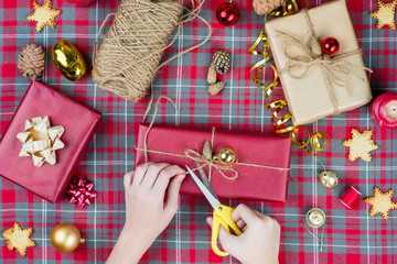 Female hands wrapping christmas gift box. Top view, christmas  concept