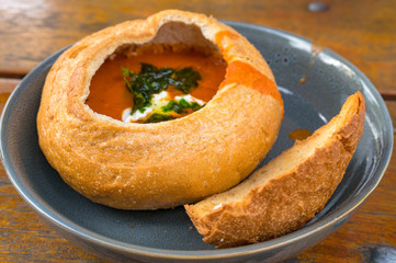 Tomato cream soup, soup puree served in round bread