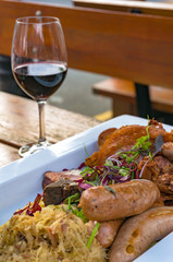 German sausages with meat, vegetables and sauerkraut, cabbage