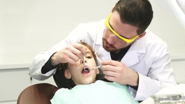 A sweet girl undergoes an annual examination at the dentist