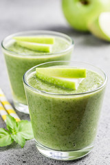 Fresh mint green apple smoothie on concrete background. Selective focus, space for text. 