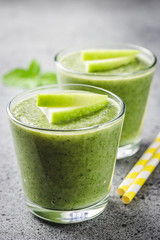 Healthy matcha apple smoothie on concrete background. Selective focus, space for text.