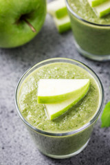 Matcha green tea apple smoothie on concrete background. Selective focus, space for text. 