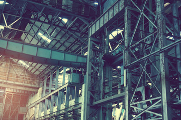 Inside of old abandon factory. A structure interior of industry warehouse. An abandon old factory with no equipment and machine. Image of rustic factory room structure made from iron and steel.